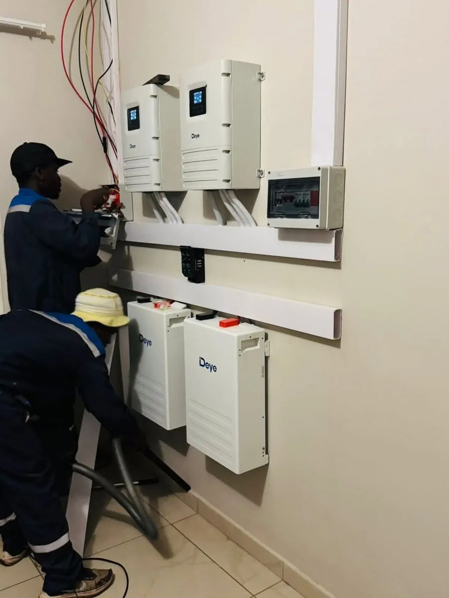 Solar installation team working on Deye battery equipment
